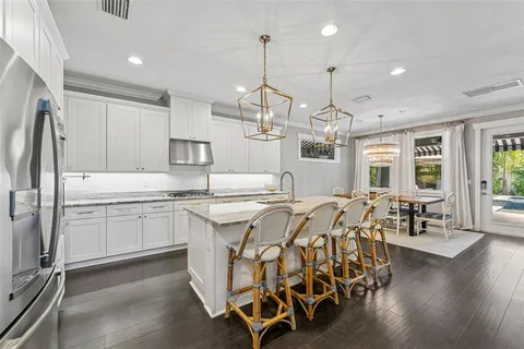 a kitchen with stainless steel appliances a white stove top oven a sink dishwasher and a refrigerator