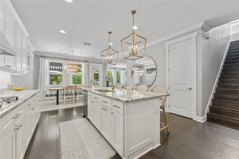 a kitchen with stainless steel appliances granite countertop a sink and a stove