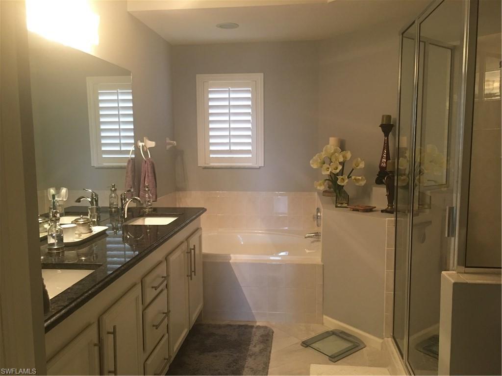 23091 Rosedale Drive, Unit 101 Estero, FL 34135 - Photo 4 of 12 a bathroom with a granite countertop sink toilet and shower
