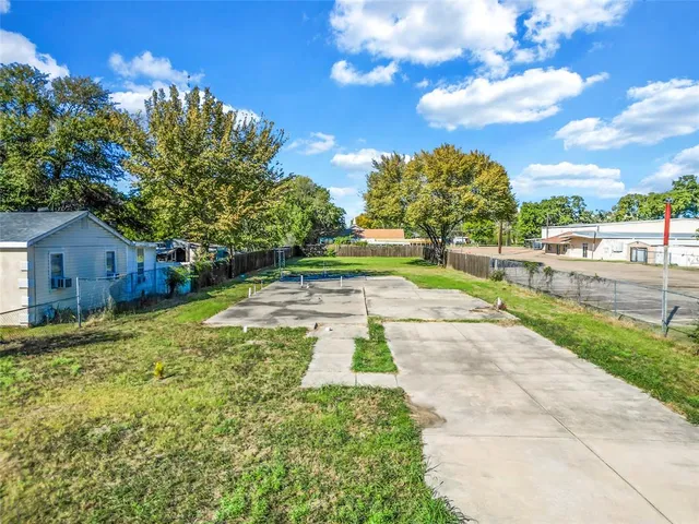 a view of backyard with swimming pool and seating