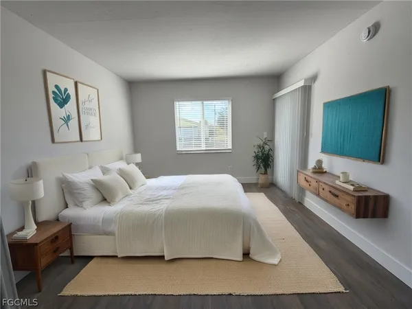 a bedroom with a bed and a flat screen television