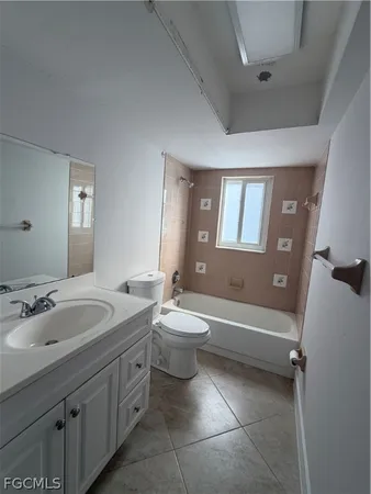 a bathroom with a double vanity sink toilet mirror and bathtub