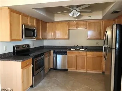 a kitchen with stainless steel appliances granite countertop a stove a sink and a refrigerator