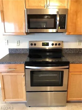 a stove top oven sitting inside of a kitchen