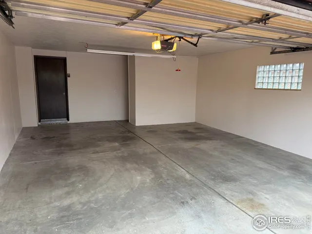 a view of house with car parked in front of house