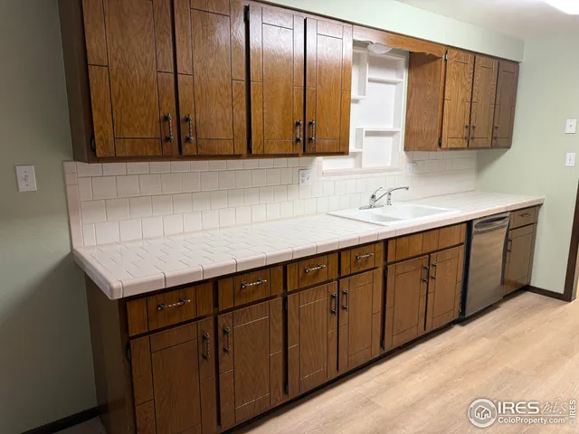 a kitchen with a sink a cabinets and window