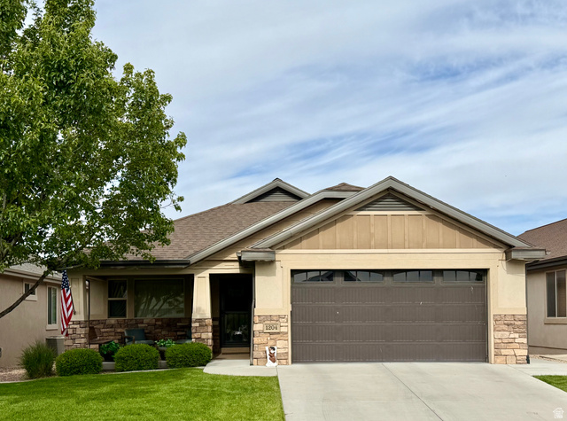 Ranch-style residence featuring a prominent two-car garage