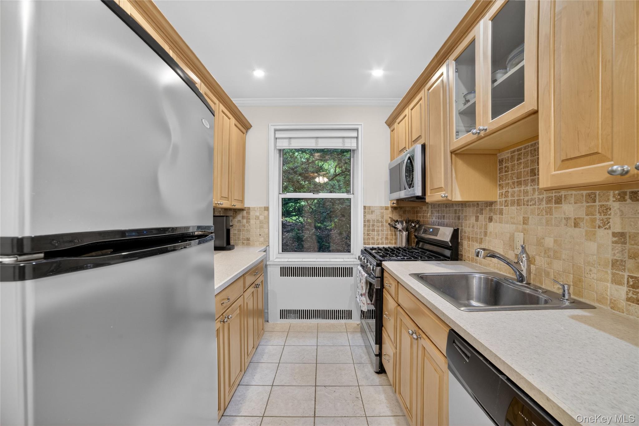824 Palmer Road, Unit 1F Bronxville, NY 10708 - Photo 9 of 26 a kitchen with a refrigerator a sink and a cabinets