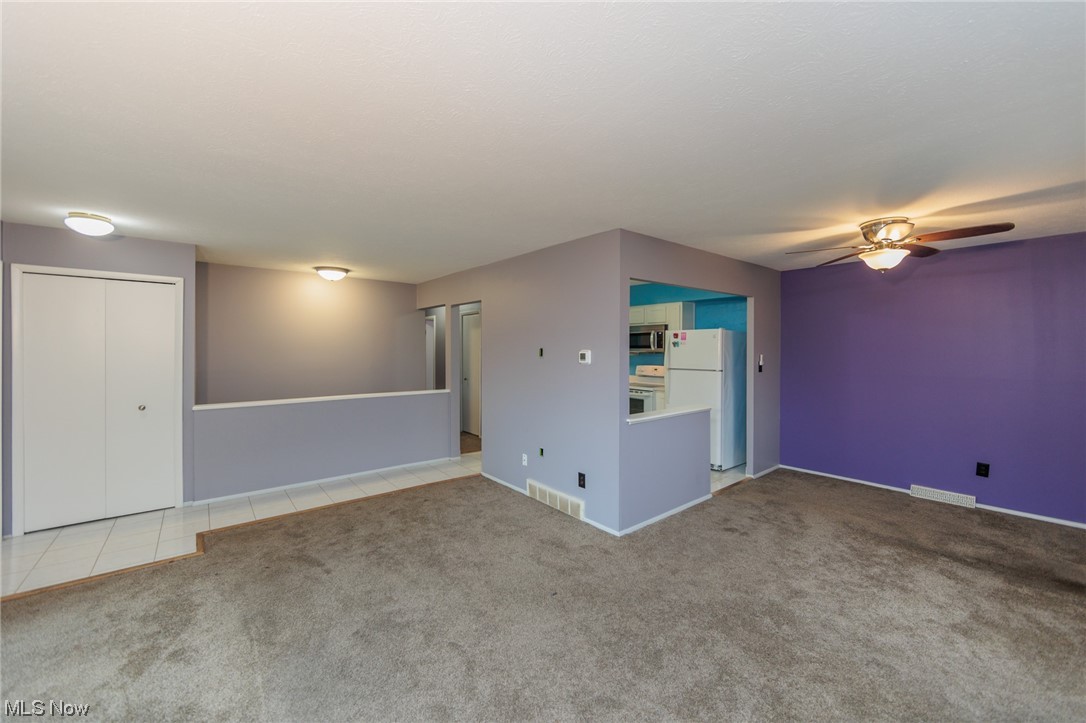 6472 State Road, Unit J19 Parma, OH 44134 - Photo 12 of 33 Empty room with light tile flooring and ceiling fan