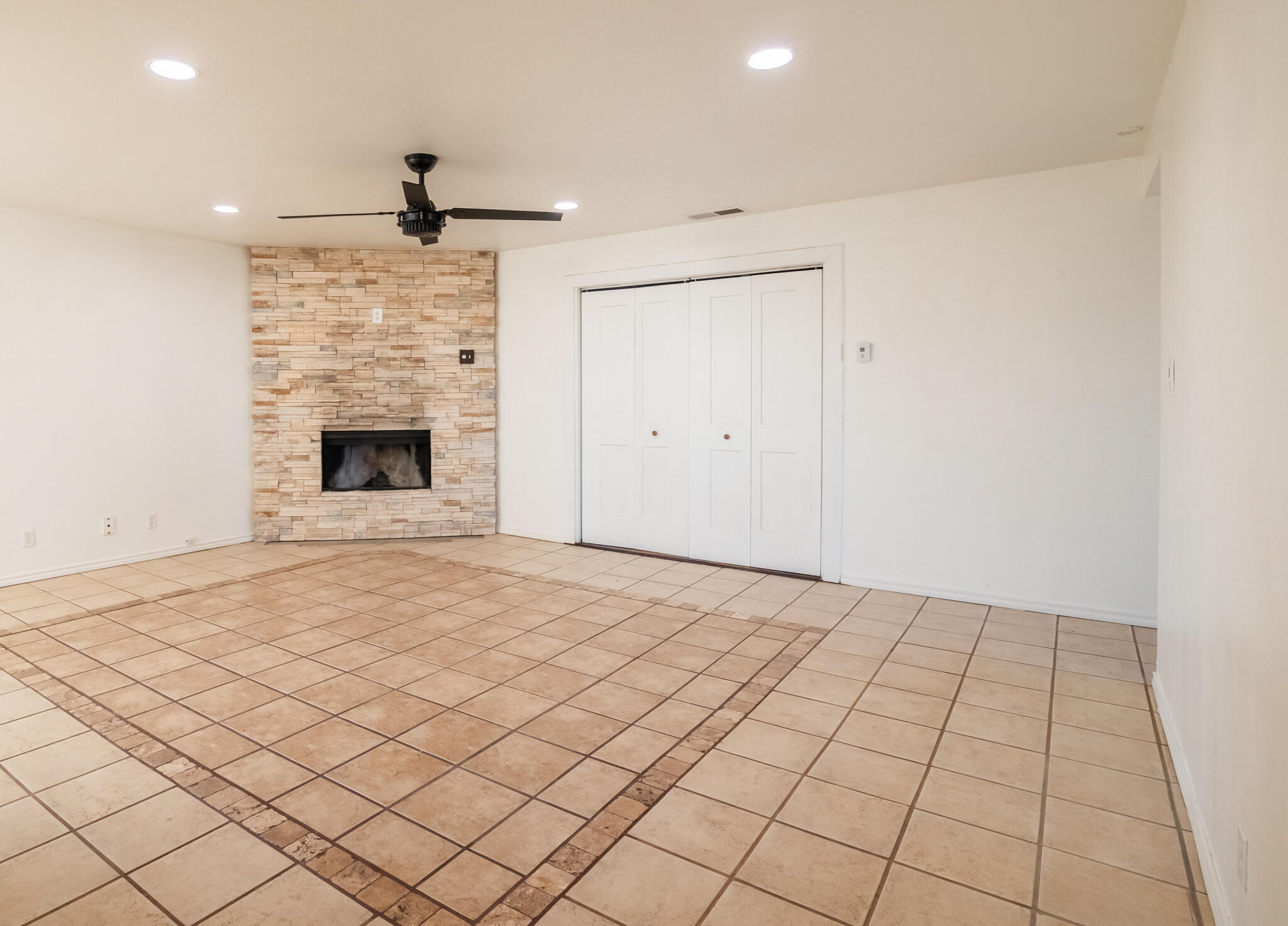 6917 Highway 114 Lubbock, TX 79407 - Photo 15 of 45 an empty room with fireplace and windows