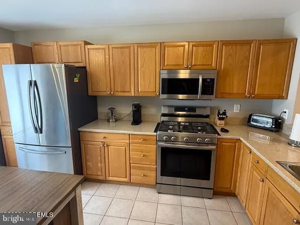 a kitchen with a stove microwave and refrigerator