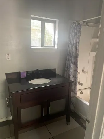 a bathroom with a sink a toilet a mirror and shower