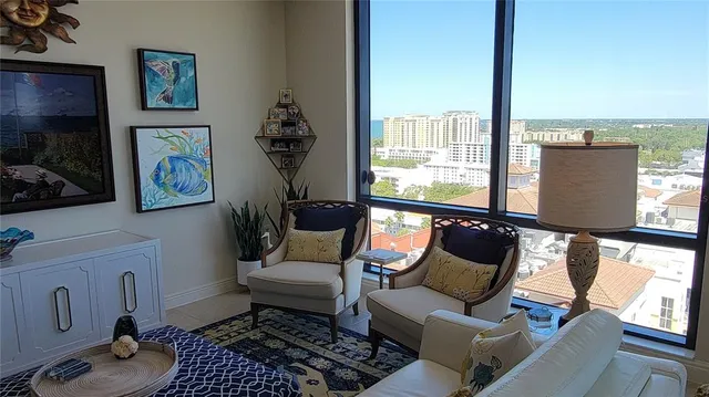 a bedroom with a bed and a lamp on dresser
