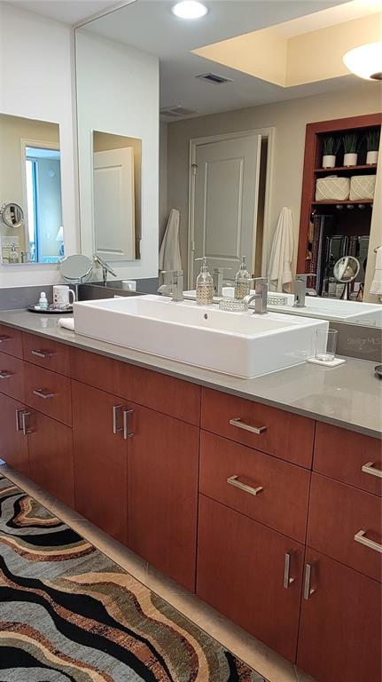 50 Central Avenue, Unit 16A Sarasota, FL 34236 - Photo 16 of 44 a bathroom with a granite countertop sink and a mirror