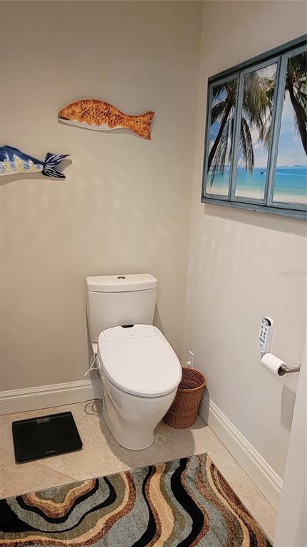50 Central Avenue, Unit 16A Sarasota, FL 34236 - Photo 18 of 44 a bathroom with a toilet and a picture on the wall