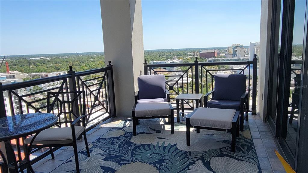 50 Central Avenue, Unit 16A Sarasota, FL 34236 - Photo 19 of 44 a view of a chairs and table in patio with a lake view
