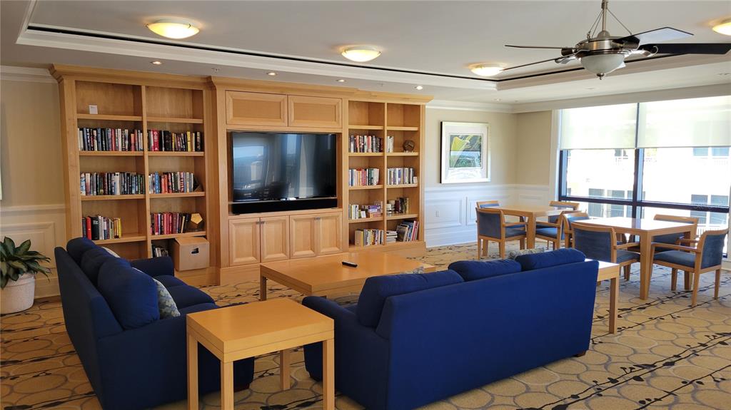 50 Central Avenue, Unit 16A Sarasota, FL 34236 - Photo 32 of 44 a living room with furniture a flat screen tv and a window