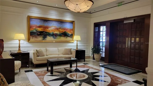 a living room with furniture and a painting on the wall