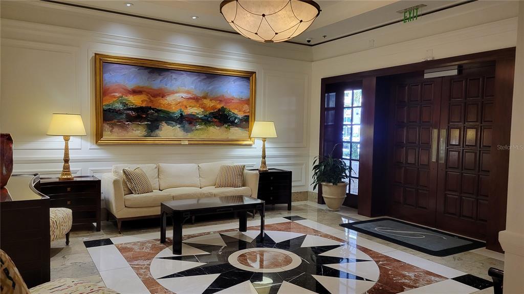 50 Central Avenue, Unit 16A Sarasota, FL 34236 - Photo 4 of 44 a living room with furniture and a painting on the wall