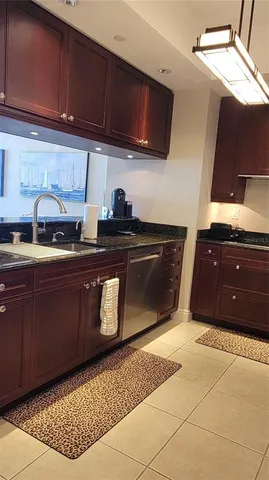 a kitchen with stainless steel appliances granite countertop a sink a stove and a microwave