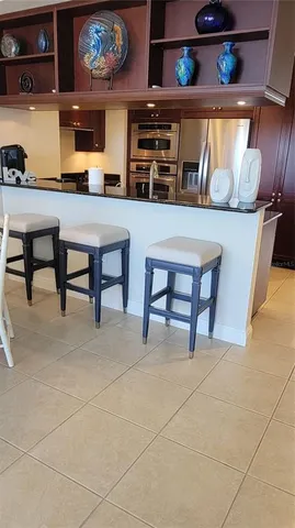 a kitchen with a sink a stove and cabinets
