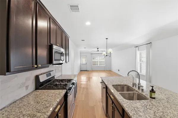 an empty room with fan and windows