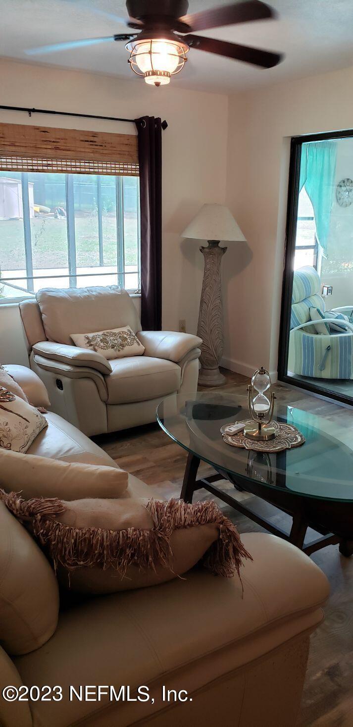 11451 Trip Avenue Weeki Wachee, FL 34614 - Photo 14 of 46 a living room with furniture and a large window