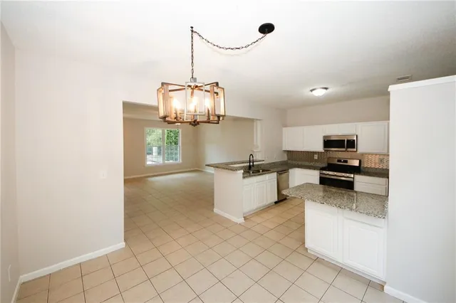 a kitchen with stainless steel appliances granite countertop a sink and a stove