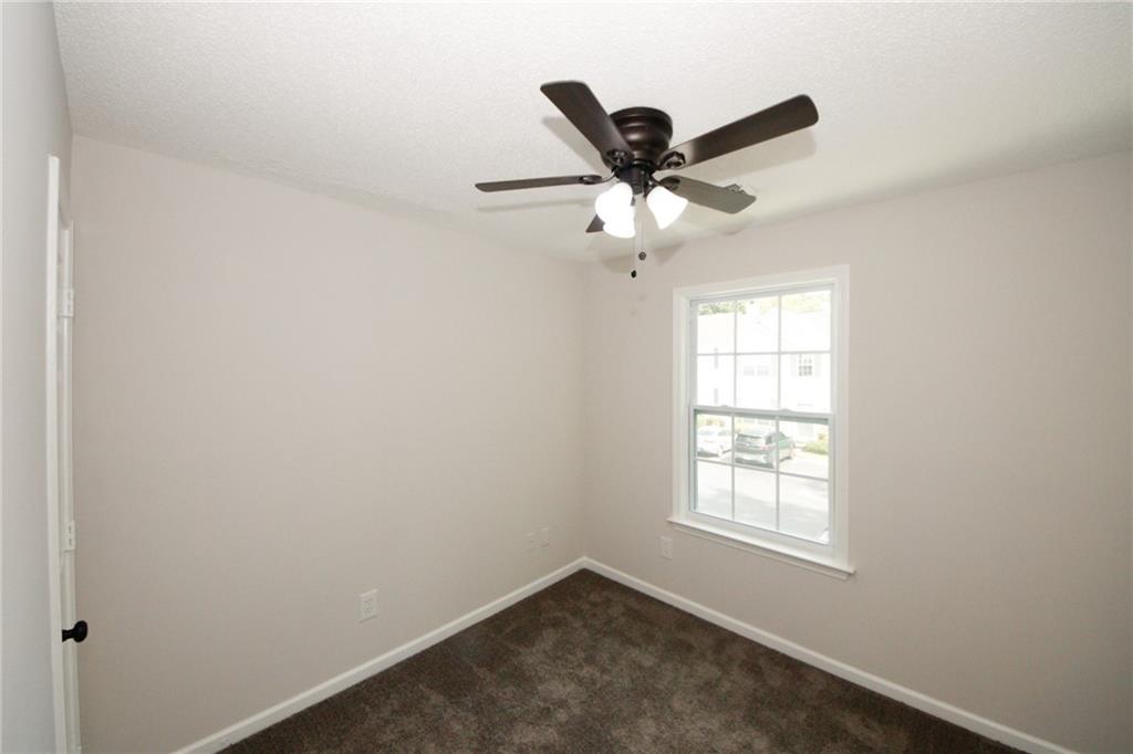 4645 Valais Court, Unit 90 Alpharetta, GA 30022 - Photo 13 of 24 an empty room with windows and fan