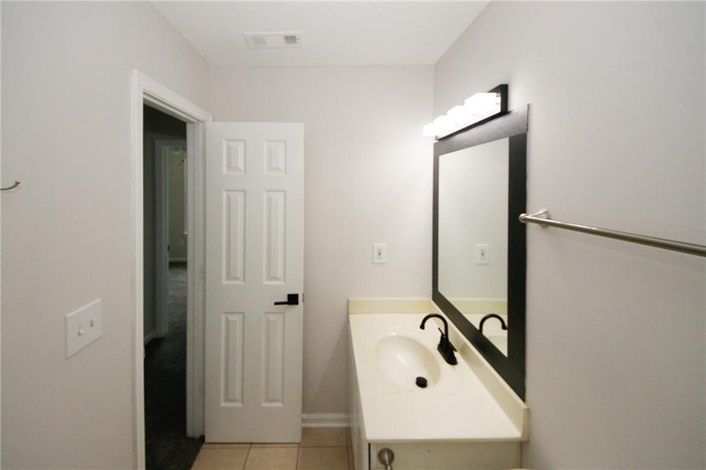 4645 Valais Court, Unit 90 Alpharetta, GA 30022 - Photo 15 of 24 a bathroom with a sink and mirror