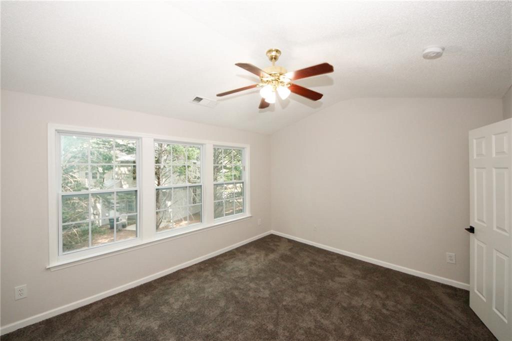 4645 Valais Court, Unit 90 Alpharetta, GA 30022 - Photo 19 of 24 an empty room with a window and a fan