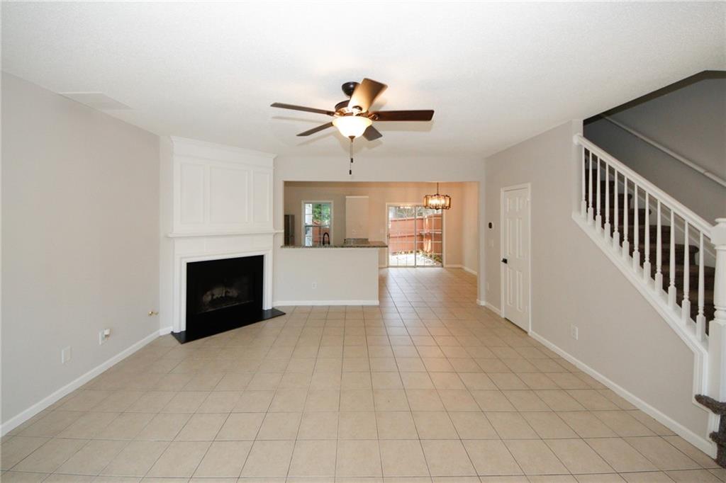 4645 Valais Court, Unit 90 Alpharetta, GA 30022 - Photo 2 of 24 a view of a livingroom with a fireplace a ceiling fan and windows