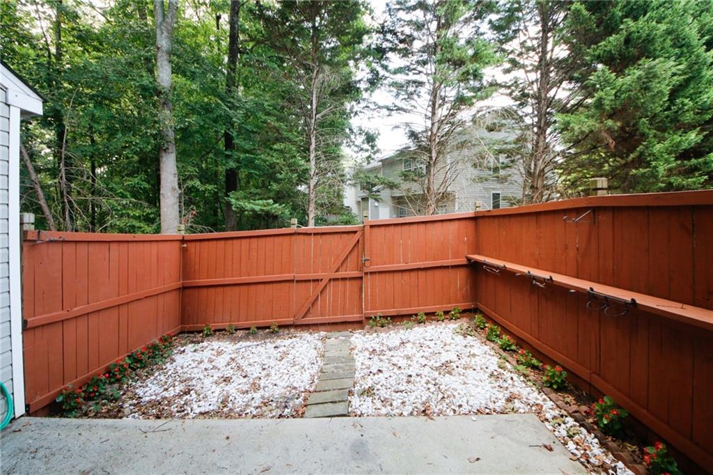 4645 Valais Court, Unit 90 Alpharetta, GA 30022 - Photo 23 of 24 a view of a small space with wooden fence