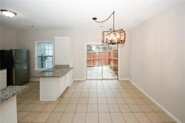 a kitchen with granite countertop a stove a refrigerator and a sink