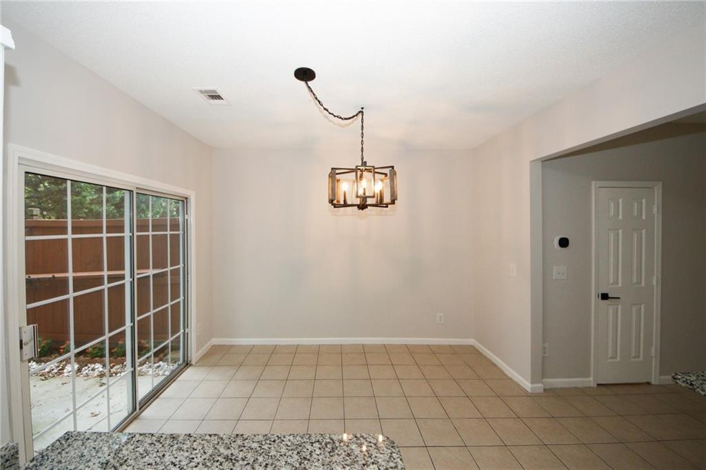 4645 Valais Court, Unit 90 Alpharetta, GA 30022 - Photo 9 of 24 a view of a room with wooden floor and windows