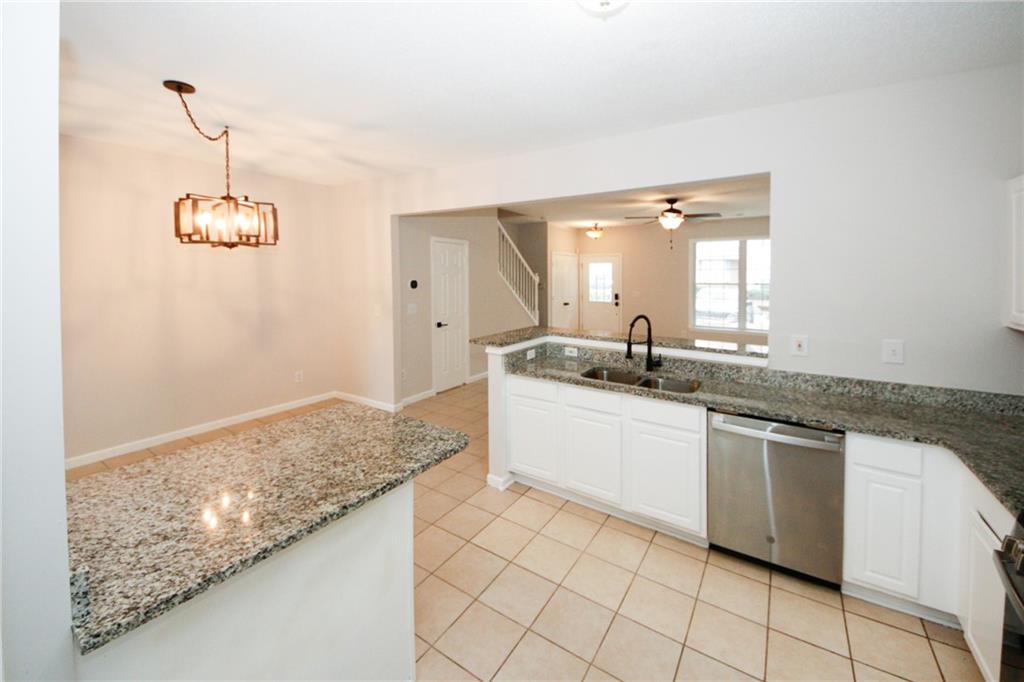 4645 Valais Court, Unit 90 Alpharetta, GA 30022 - Photo 10 of 24 a bathroom with a granite countertop sink and a mirror