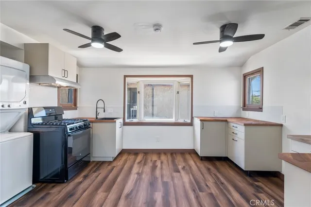 a kitchen with cabinets and wooden floors