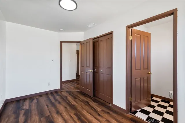 a view of a room with wooden floor and white walls