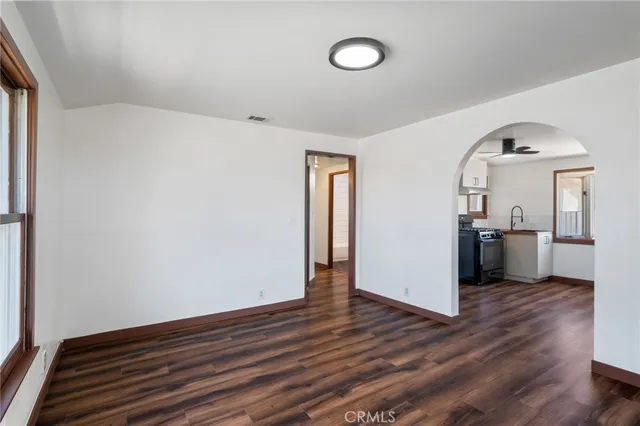 a view of a kitchen with wooden floor and electronic appliances