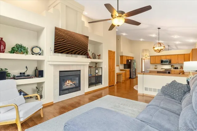 a living room with furniture kitchen view and a fireplace