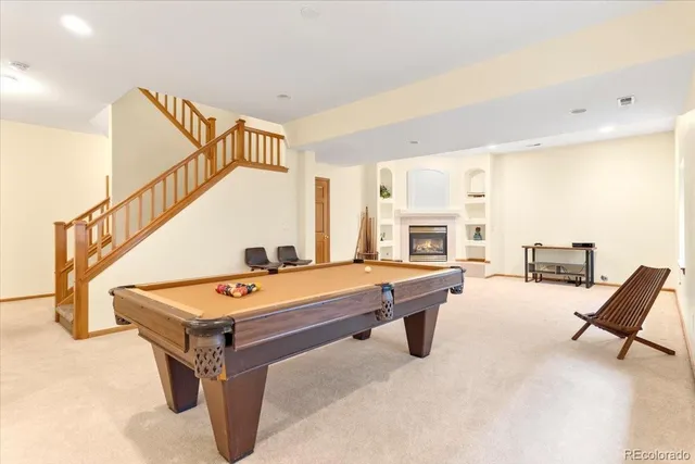 a room with pool table and flat screen tv
