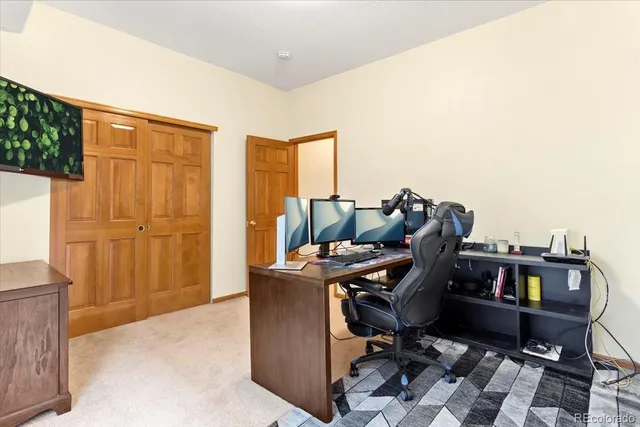 a view of a workspace with furniture and cabinet
