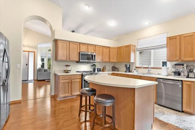 a kitchen with a sink a center island and a window