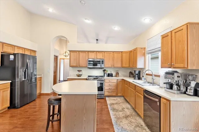 a large kitchen with stainless steel appliances lots of counter space and a sink