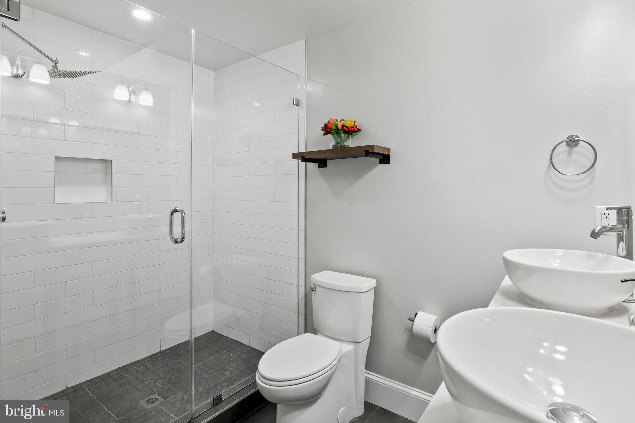 2221 M Street Northeast, Unit PH1 Washington, DC 20002 - Photo 13 of 38 a bathroom with a toilet sink and shower