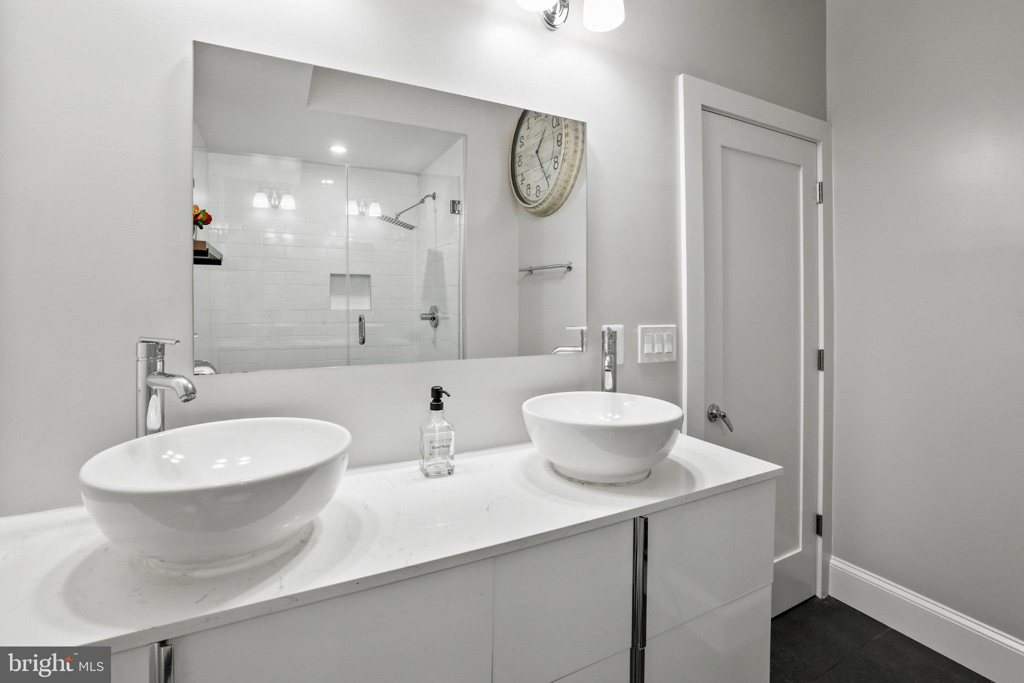 2221 M Street Northeast, Unit PH1 Washington, DC 20002 - Photo 14 of 38 a bathroom with a double vanity sink mirror and toilet