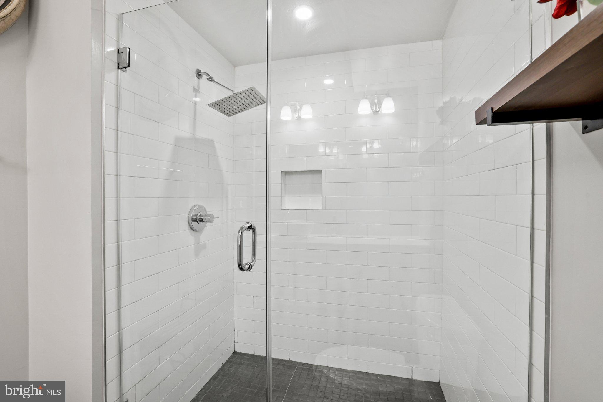 2221 M Street Northeast, Unit PH1 Washington, DC 20002 - Photo 15 of 38 a bathroom with a glass shower door