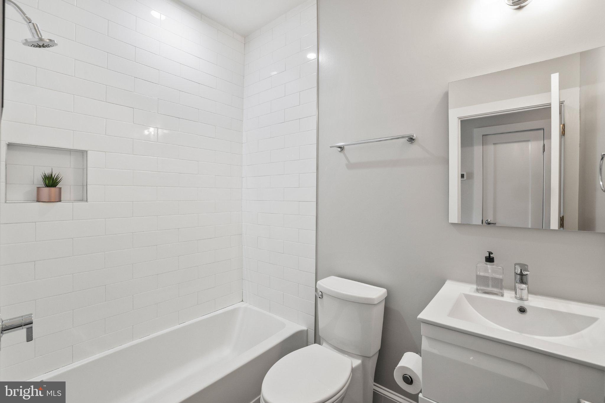 2221 M Street Northeast, Unit PH1 Washington, DC 20002 - Photo 16 of 38 a bathroom with a toilet sink and shower