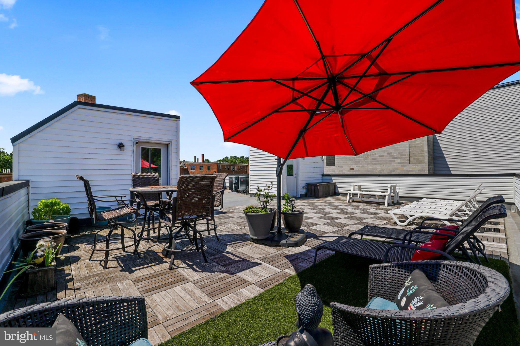 2221 M Street Northeast, Unit PH1 Washington, DC 20002 - Photo 28 of 38 a view of patio with chairs and table under an umbrella