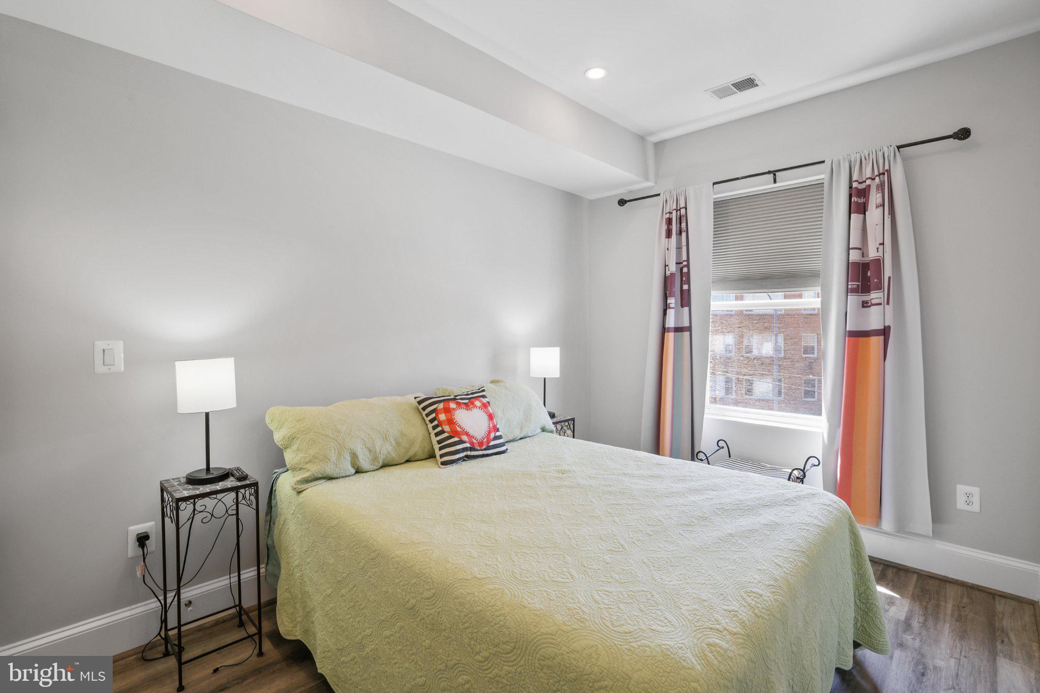 2221 M Street Northeast, Unit PH1 Washington, DC 20002 - Photo 10 of 38 a bedroom with a bed and a night stand